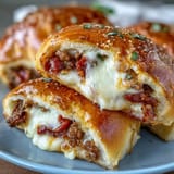 Savory Irresistible High Protein Pepperoni Pizza Rolls reveal melty mozzarella and pepperoni inside soft, protein-rich dough.