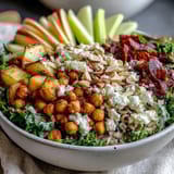 Crispy chickpeas and roasted sweet potatoes top a vibrant Fall Harvest Bowl with kale and wild rice. 