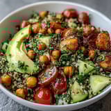 Fresh lemon vinaigrette grain bowls with roasted chickpeas, quinoa, avocado, and colorful veggies in a vibrant, healthy meal prep bowl.  