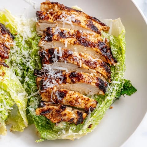 Overhead view of a Caesar Chicken Sandwich with melted Parmesan and fresh tomato slices, perfect for a quick lunch idea.  