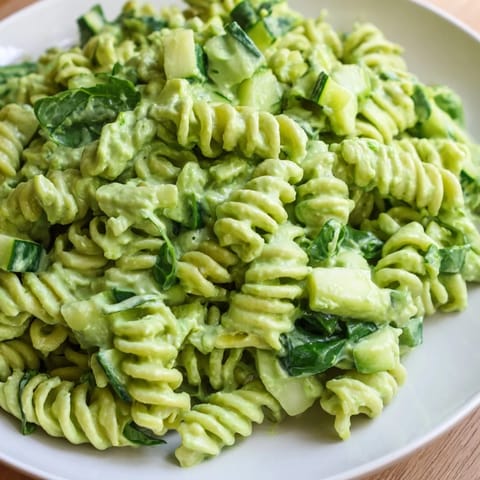 Green Goddess Pasta Salad served chilled in a white bowl, garnished with fresh basil and chives, perfect for a light lunch.